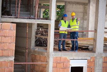 Male architect and his partner planning future building