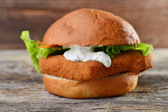 Fresh and fried fish burger with vegetables