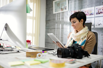 Business woman designs photos on computer