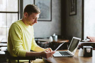 Young blogger at a table in the bar