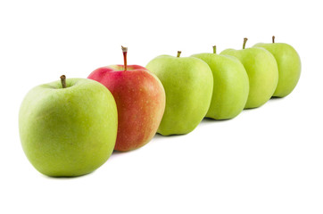 Red apple in a row of green apples