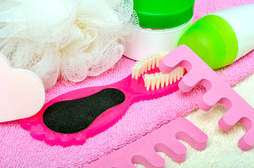 Foot care. Pedicure set on a pink towel.