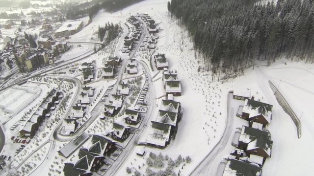 Aerial shot of houses on the hill in winter