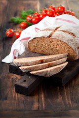Homemade whole wheat bread with sundried tomatoes and herbs, selective focus