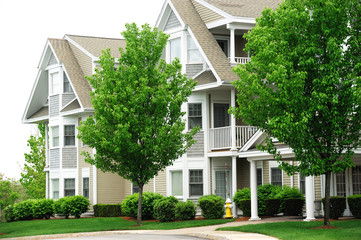 apartment building with spring trees landscape