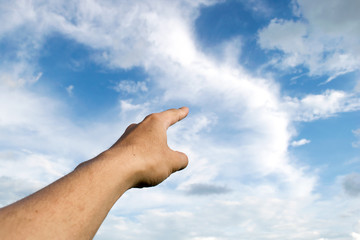 Man pointing his hand and cloud sky background