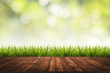 Wooden floor, grass and green blurred background