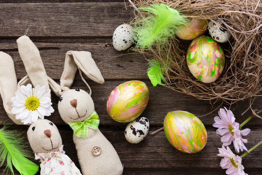 Easter background with colorful eggs in nest and home made banni