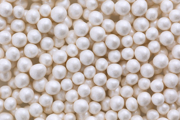 White pearl dragee balls background