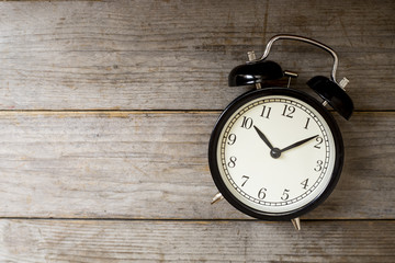 Retro alarm clock on wooden table