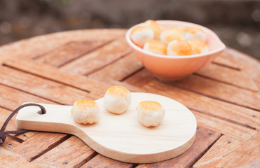 Mini Chinese cakes on wooden plate