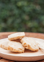 Fototapeta na wymiar Cashew cookies on wooden plate