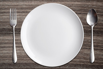 Top view White dish spoon fork on wood background