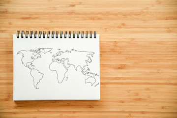 World map outline on notebook