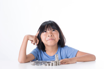 Cute Little asian girl and pile coin for saving. money concept  in thinking action with white background