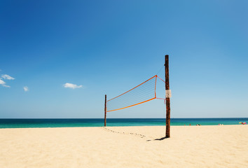 Volleyball net on the beach and tropical sea