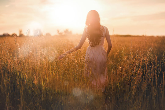 She goes through the ears on the sunset viewed from behind