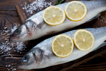 Close-up of fresh uncooked seabass with lemon and sea salt