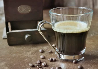 Fotobehang Koffiebar kopje koffie op houten tafel met molen en koffiebonen