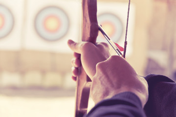 image of Archer holds his bow aiming at a target