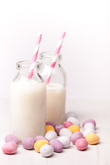 chocolate mini easter eggs and milk in small milk bottles with pink striped straws