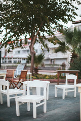 white wooden chairs of street cafe