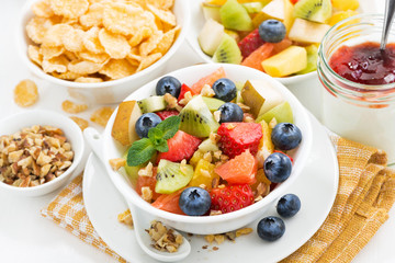 breakfast with fruit salad and corn flakes, top view
