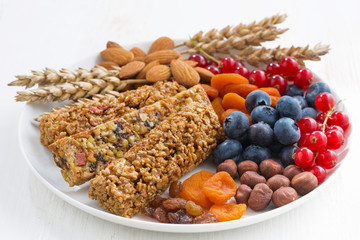 cereal muesli bars, fresh and dried fruit on a plate