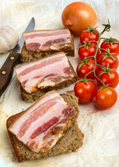 Sandwiches of rye bread with bacon.
