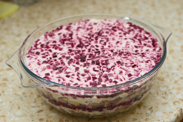 Salad Herring under a fur coat in a glass dish.