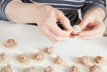 Housewife preparing meat dumplings
