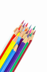 Many colored wooden pencils on white.