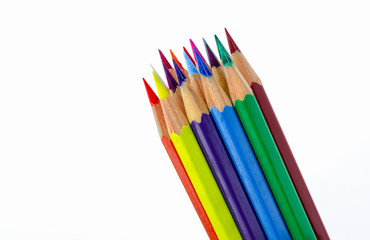 Many colored wooden pencils on white.