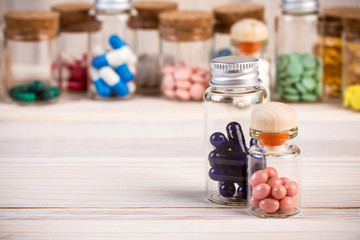 Various alternative and homeopatic pills in wooden containers