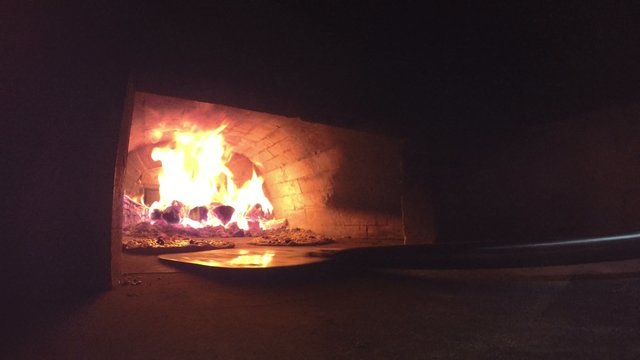 UHD Video of Pizza in an Oven with Burning Fire