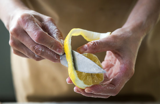 Chef peeling a lemon