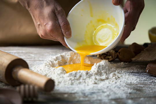 Man mixing flour and eggs