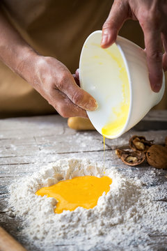 Man mixing flour and eggs