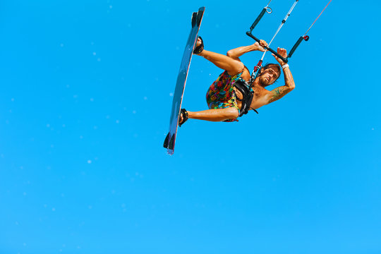 Kiteboarding, Kitesurfing. Water Sports. Professional Kite Surfer In Action In Air. Extreme Sport In Ocean. Healthy Active Lifestyle. Recreational Sporting Activity. Summer Fun, Hobby. Adrenaline.