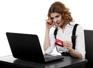 Suspicious businesswoman with credit card