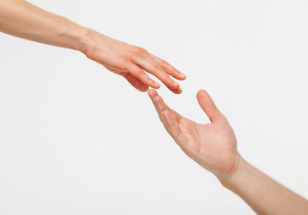 Hands of man and woman reaching out to each other