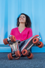 Young woman with rollerskates