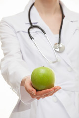 Doctor holding a fresh green apple