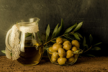 Olives and olive oil in glass jar