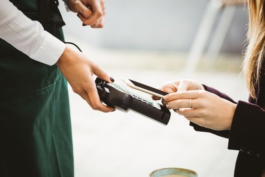 Woman paying with mobile phone