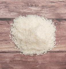 Fototapeta na wymiar Dried coconut powder over wooden background