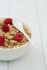Granola in a bowl with raspberries, muesli