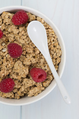 Granola in a bowl with raspberries, muesli