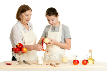 the grandmother and the granddaughter cut off a peel from apple