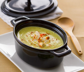 Zucchini soup in a small black cooking pot